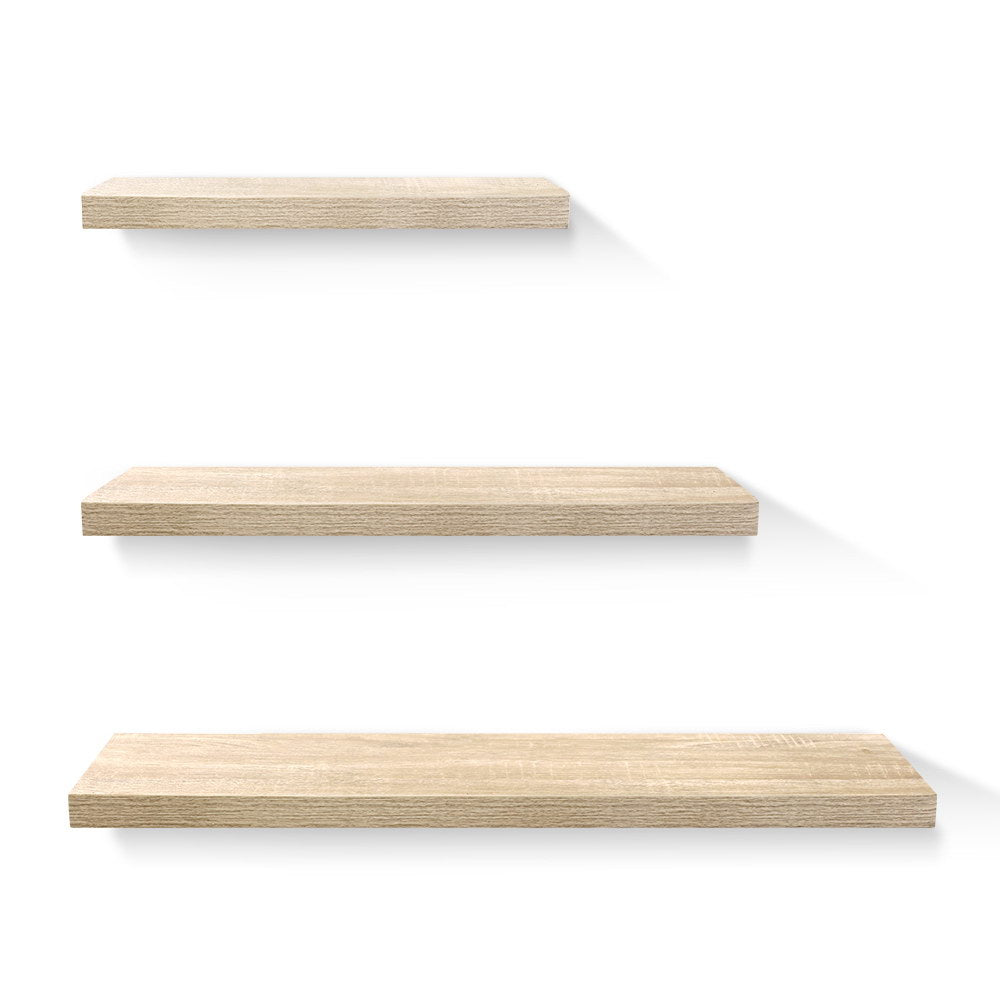 Floating wall shelf set in sturdy oak with three sizes from The Willow Stone Collective, ideal for living room storage and display.
