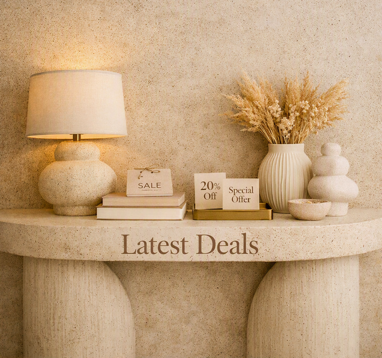 Warm decorated table featuring a lamp, books, and curated decor highlighting the latest discounts and offers.