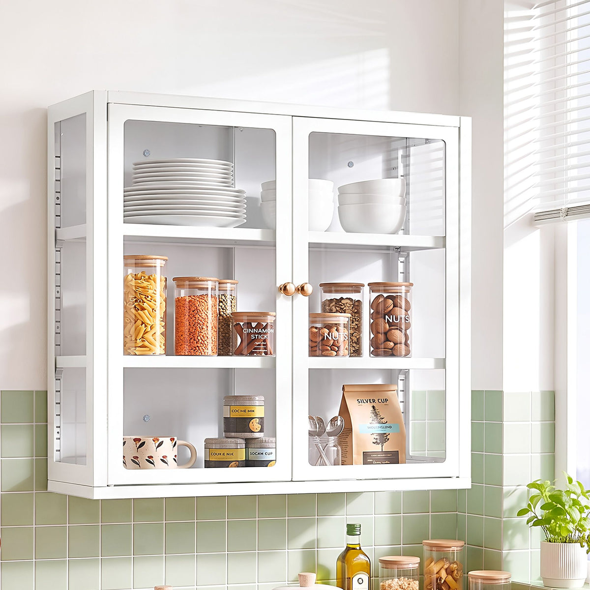 Modern glass display cabinet featuring clear glass doors, adjustable shelves and curated kitchenware in a warm, inviting setting.
