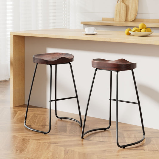 Two tractor seat bar stools with elegant pine wood seats and black steel bases in a modern kitchen setting.