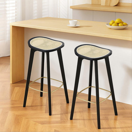 Rattan bar stools for kitchen featuring a modern two-tone design, woven rattan seats and bamboo legs with a gold footrest.