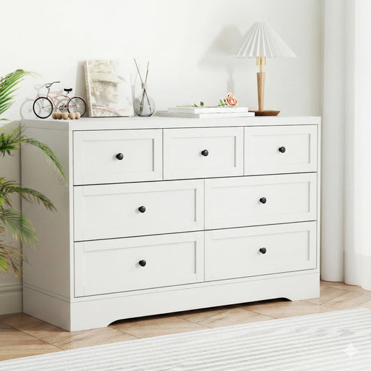 7 drawer white dresser in a serene setting with modern decor and warm tones.