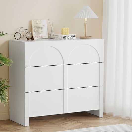3-drawer white lowboy dresser with smooth sliding drawers and modern concave-front design in a cozy setting.
