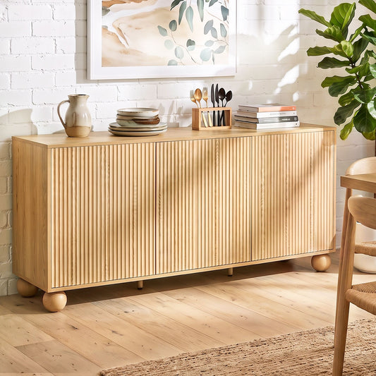 Modern japandi sideboard cabinet with fluted doors and warm timber finish, styled with decor and greenery.