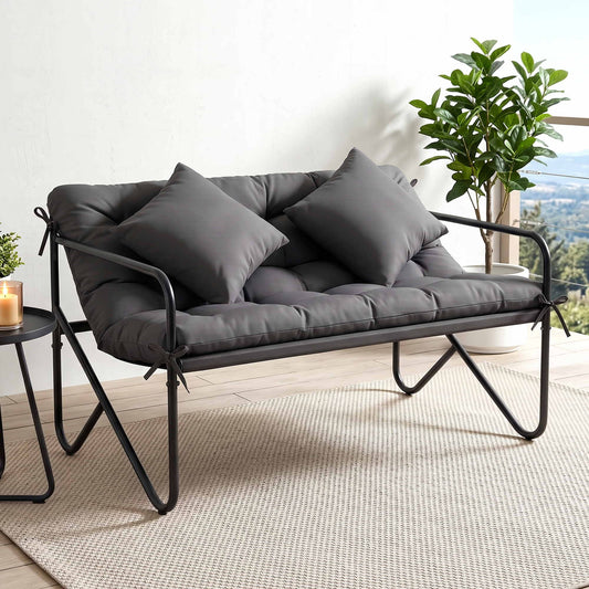 Outdoor metal garden bench with cushion elegantly designed for two, featuring plush cushions and durable metal frame.