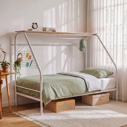 Kids metal canopy bed frame featuring a house-shaped design with overhead storage and soft green bedding.