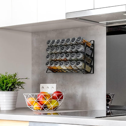 Four-tier spice rack organizer with 28 glass jars, labels, funnel, and marker for kitchen countertop storage.