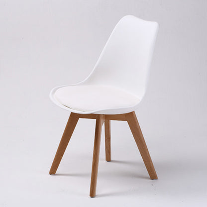 Set of four retro dining chairs with padded white seats and beech wood legs from The Willow Stone Collective.