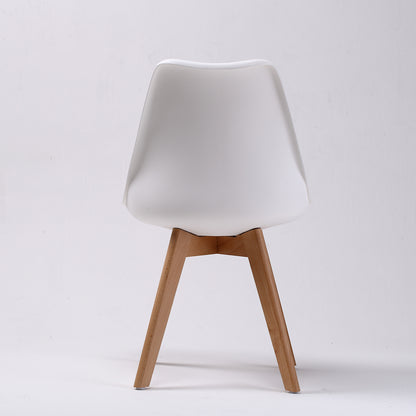 Set of four retro dining chairs with padded white seats and beech wood legs by The Willow Stone Collective.