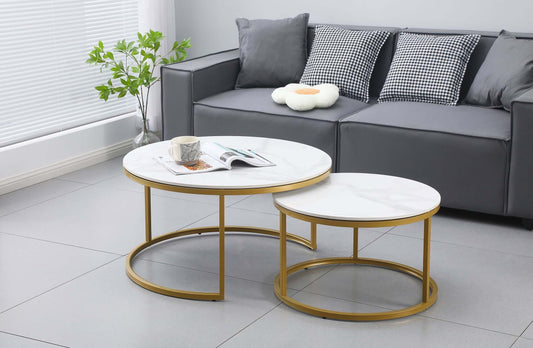Nesting Style Coffee Tables in white marble with champagne gold frames in modern living room setting.
