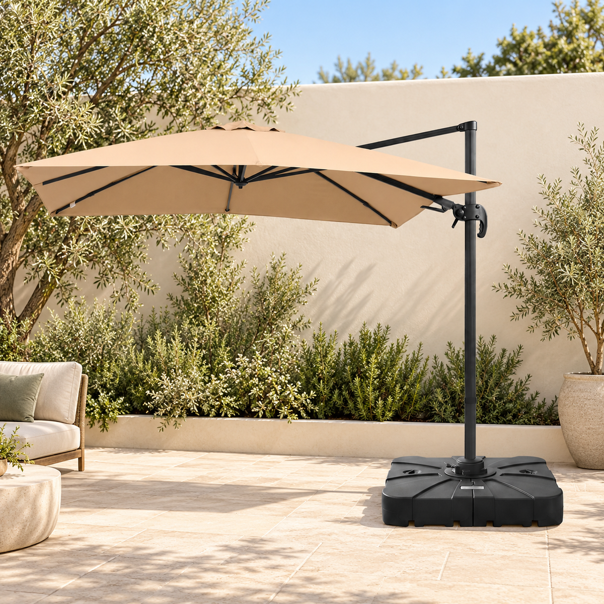 Beige 3m cantilever umbrella with included black base on a sunlit courtyard patio