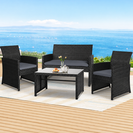 4-Piece Outdoor Rattan Sofa Set with Storage Cover – Black styled in a lifestyle setting